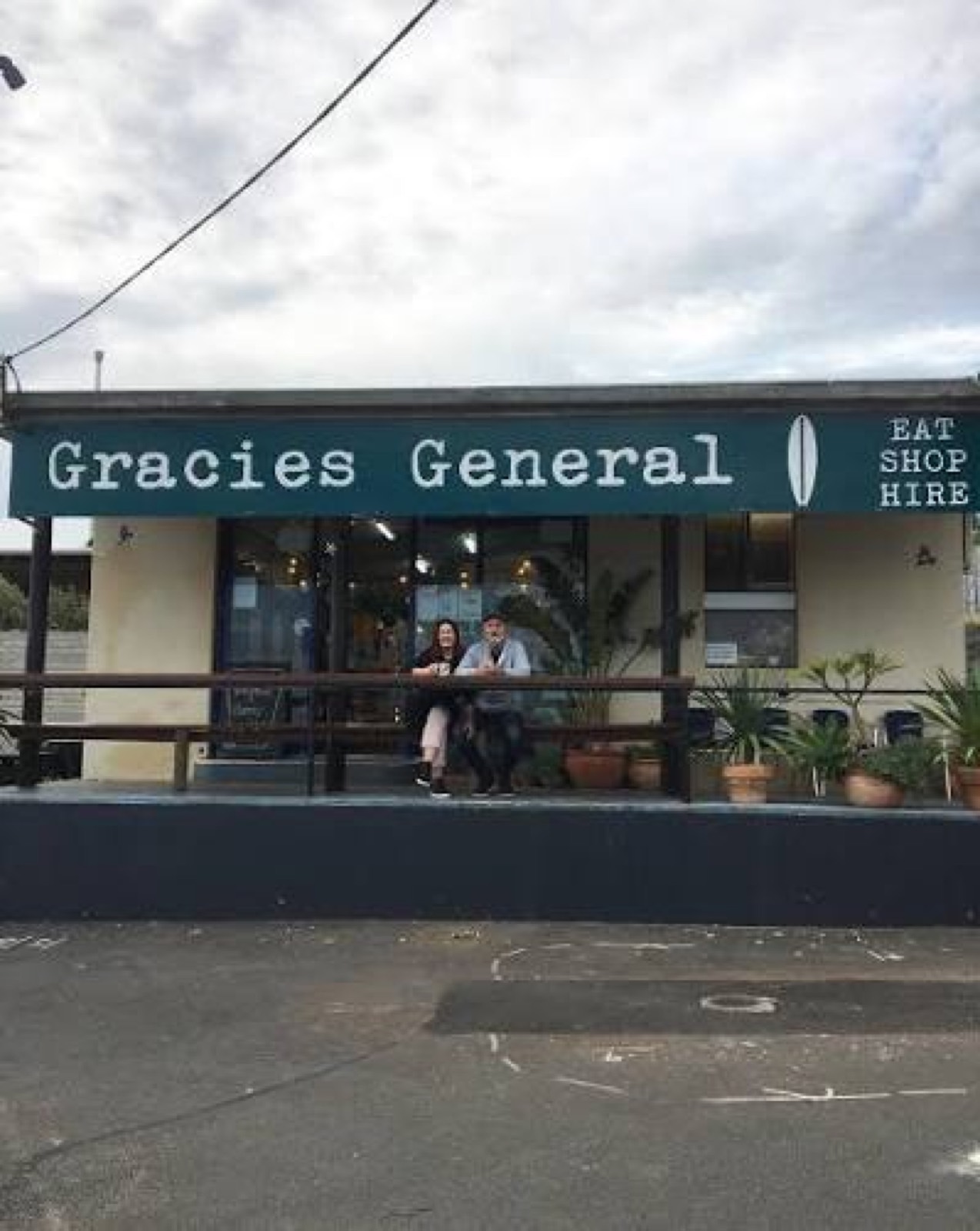 The Gracies General facade reading EAT SHOP HIRE, with people sitting out front among pot plants